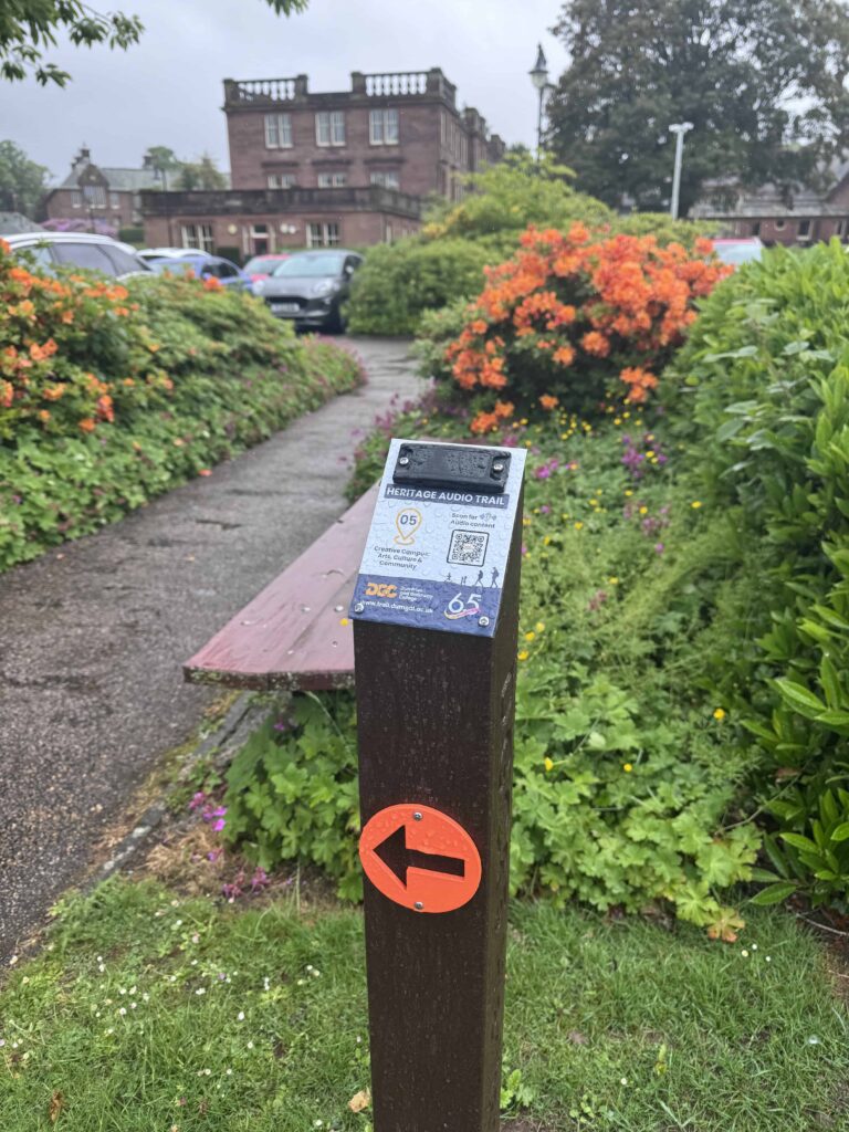 Waymarker 5 on the DGC Heritage Audio Trail by Annandale House opposite the car park in front of Crichton Central