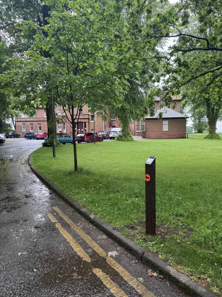 Waymarker 2 of the DGC Heritage Audio Trail in front of Carmont House